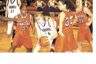 Sumner High’s Ashley Delaney protects the ball against Lakes defenders during Feb. 3 action on the Spartans’ home court.