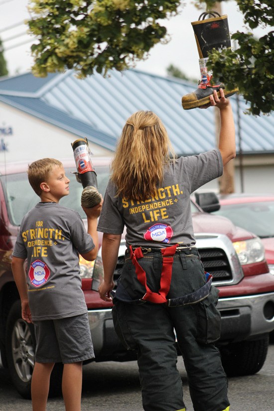 Heidi Rolfsness and her son Kaden Fill the Boot in Sumner on the corner of Valley Ave and Main St.