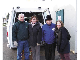 During the holidays the staff at Enumclaw City Hall staged a food drive to help out the needy in the community. Volunteers stand outside a van full of food that had been collected.