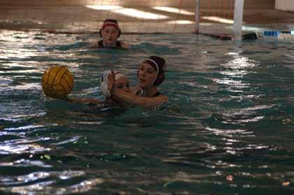 Kelsey Sonneson puts pressure on a Wilson player during the opening round of the state water polo tournament May 18 at Rogers High in Puyallup. All-state honorable mention freshman Hornet keeper Megan Lesmeister pays close attention.