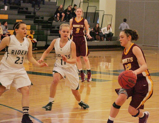 Alex Sayler for White River dribbles the up the court Port Angeles Feb 16.