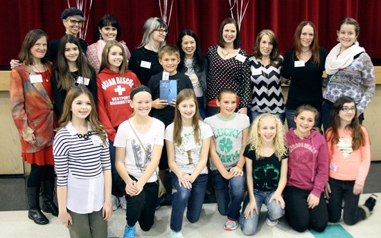 Lake Tapps Middle School students pose with local young adult novel authors.