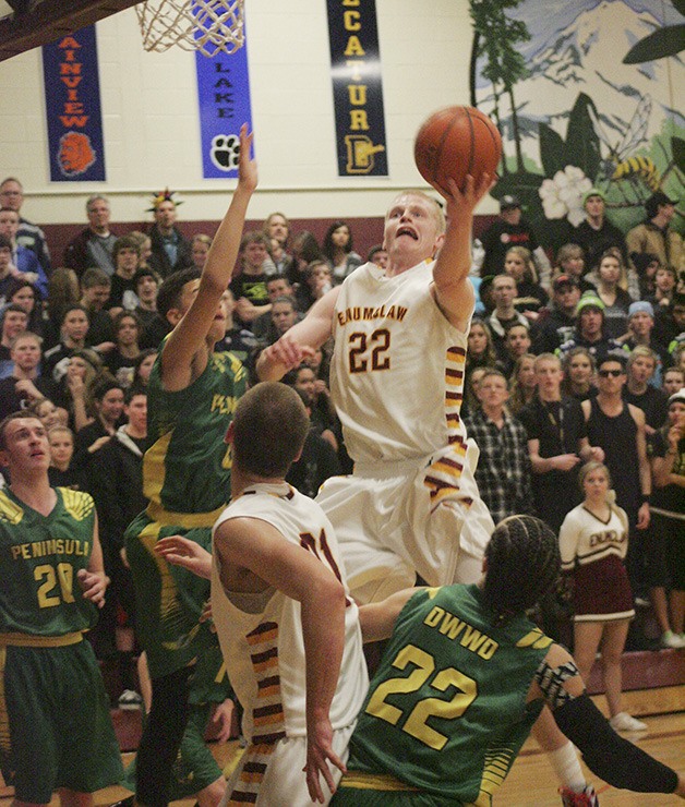 Enumclaw’s Drake Rademacher goes up for a shot against Peninsula Jan. 31.