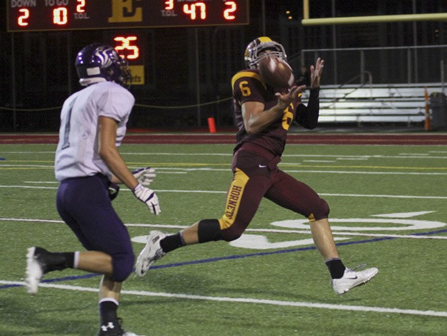 The Hornets’ Nick Conrad hauls in a pass from Peter Nordby during Friday’s rout of Heritage High.