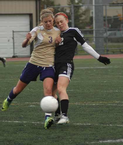 Sumner's Krista Morford gives an Archbishop Murphy player a bump during state soccer action Saturday at Sunset Chev Stadium.