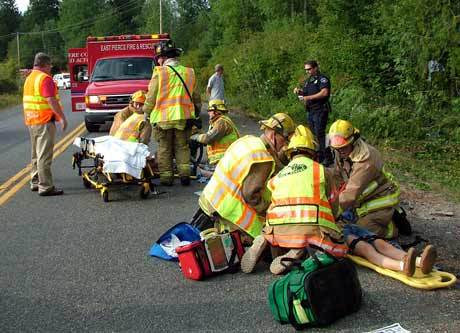 Emergency crews assist the young victims of a Saturday traffic accident just west of the Buckley city limits.