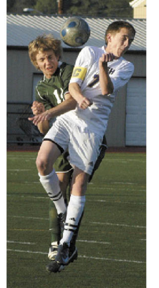 Jacob Pierce collides with a Peninsula player Friday during South Puget Sound League 3A soccer action between Sumner High and the Seahawks at Sunset Chev Stadium. The Seahawks picked up a 2-1 victory