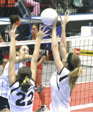 Enumclaw High’s Elizabeth Birklid (22) and Gabbi Sisco stuff a kill attempt during Thursday’s warm-up time at the Class 3A state volleyball tournament.