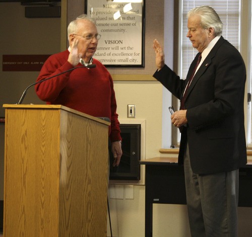 Mayor Dave Enslow swears in councilman Jon Swanson at the opening of the April 18 meeting. Swanson is the appointed sitting councilman until the November election