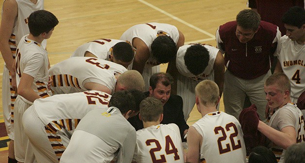 Coach Kellen Hall talks to the Hornets about the final shot of the game. The Hornets made the shot and won the game.