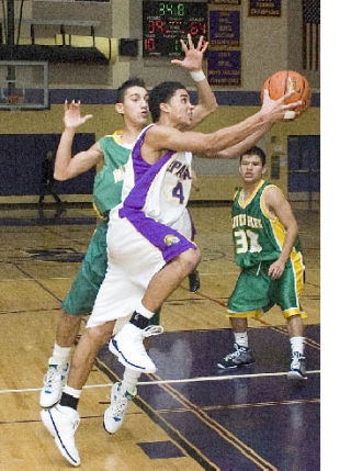 Senior guard Zeric Cage drives to the hoop for the Spartans during action with Clover Park Dec. 16. Cage scored six points for Sumner in the loss. The Spartans maintained momentum and kept within striking distance of the Warriors for a while