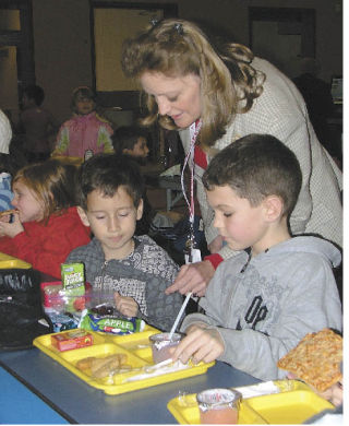 Danna Ohman shares lunchtime conversations Jan. 21 with Lake Tapps Elementary students Drew Engstrom and Jason Miller Sermeno.