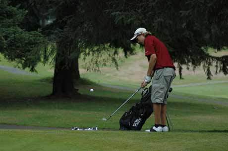 Tim Livermore chips on in from the fringe during play Friday at Enumclaw Golf Course.