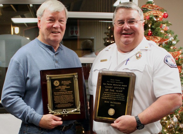 Commissioner Dale Mitchell and Assistant Chief Russ McCallion display the awards they won as part of the Pierce County Fire Commissioners' annual banquet.