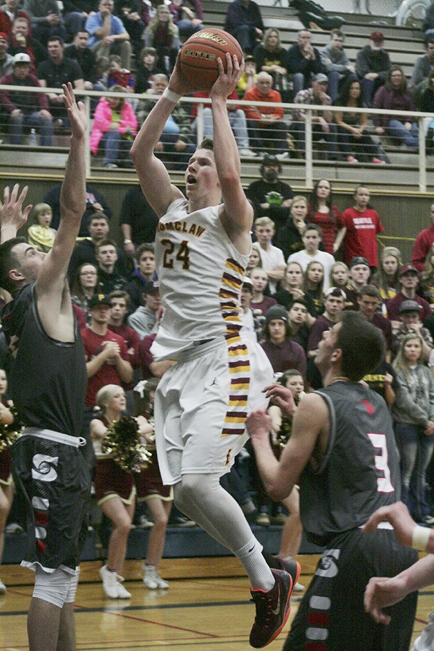 Enumclaw Hornet Josh Erickson drives to the basket Saturday at Rogers High against Stanwood.