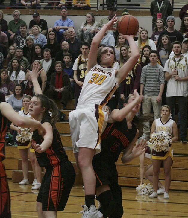 White River Hornet forward Kendall Bird shoots over Washougal defenders Saturday at Puyallup High.