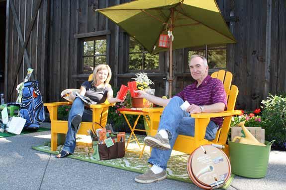 White River Superintendent Tom Lockyer and Deputy Superintendent Janel Keating pose in one of the items available for bid at the White River Education Foundation auction.