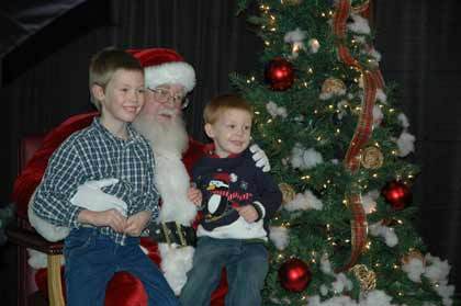 Korben and Bo Collins get an early visit with Santa Claus at the Festival of Crafts at the Enumclaw Expo Center Nov. 20 and Nov. 21.