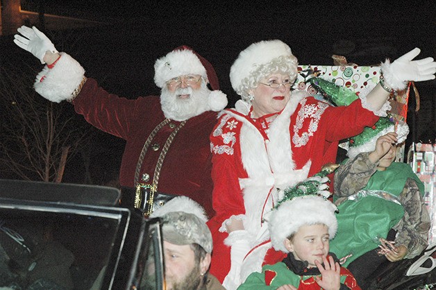 Mr. and Mrs. Santa Claus waves to the crowd during the Enumclaw Holiday Parade.