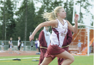 Jessica Lindner sprints her leg  of White River High School’s  200-meter relay while Michael  Madden and Nate Lenhart successfully  complete a handoff in the boys 200  relay. The Hornets found success  March 25 against Bonney Lake and  North Thurston and then again Saturday  at the Kent-Meridian Invitational at French Field