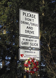 A memorial sign sits near the intersection of 214th Street and state Route 410 East.