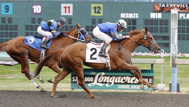 Lady Vivien and jockey Leslie Mawing combine abaord Lady Vivien for the victory over Talk to My Lawyer in the feature race for 3-year-old fillies at Emerald Downs. Larry Ross is the trainer for Oak Crest Farm LLC. August 26