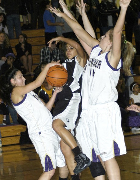 Panther Marcel Pounds is triple-teamed by Sumner High’s Angie Wagar-Sanchez