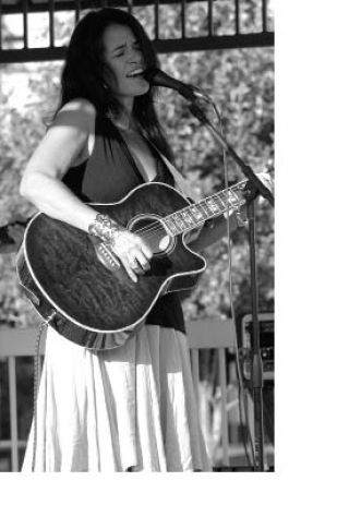 Kellee Bradley sings during her Friday performance at Music on Main Street at Heritage Park in Sumner. About 200 people gathered around the gazebo under sunny skies.