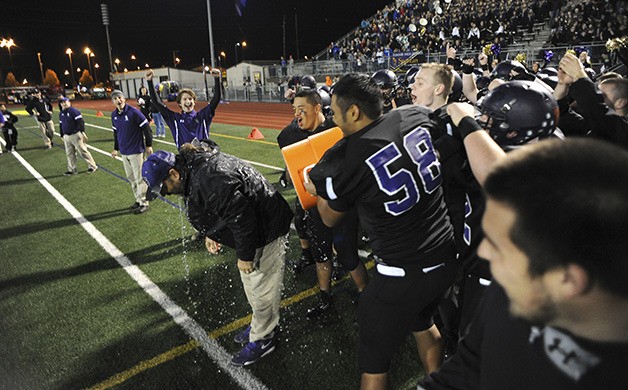 Spartan coach Keith Ross gets a water bath following the win over White River Friday at Sunset Chev Stadium Friday. Sumner finished the season undefeated.