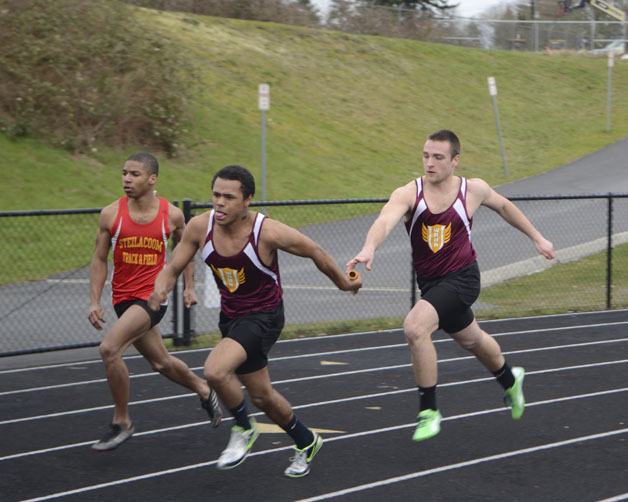The Hornets’  Xavier Russell takes the baton from Josh Miller during a White River relay March 21 against Washington and Steilacoom.
