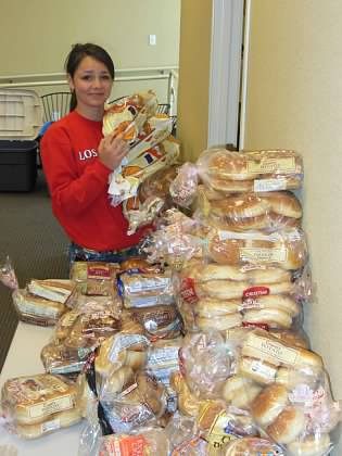 Enumclaw Middle School student Rylee Agnew organizes packages of buns while volunteering at the Plateau Outreach Ministries food bank.