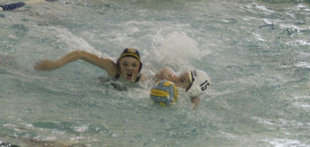 Brittney Tuffs battles an Auburn Mountainview athlete for the ball at Tuesday's water polo match.