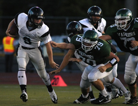 Bonney Lake quarterback Cole Schuler escapes from a group of Clover Park defenders during the first quarter of the Panthers 28-6 win Sept. 18 at Harry Lang Stadium in Lakewood.