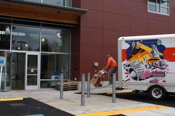 Workers move the first batch of boxes into Bonney Lake's Justice Center March 29.