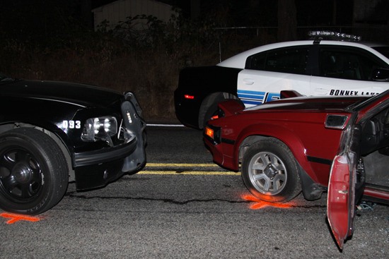 The car chase ended when the sedan was pinned between two police cars