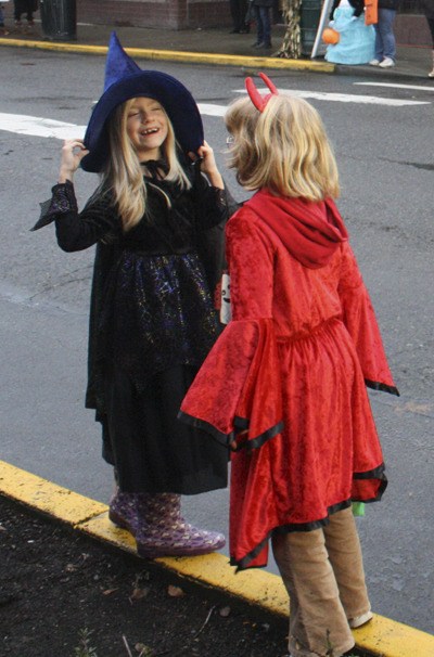 A witch and a devil scheme at the Street of Treats in Sumner.