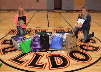 Cassidy Gordon and Madison Hart pose with the supplies they collected and donated to the Dieringer School District.