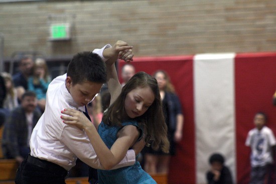 Andrew Rogers leads Sarah Swanson​ in the tango in front of their parents