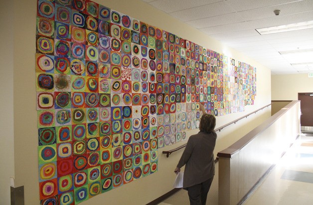 Lake Tapps principal Connie GeRoy points out the different styles utilized in the Art Docent program's Kandinsky mural.