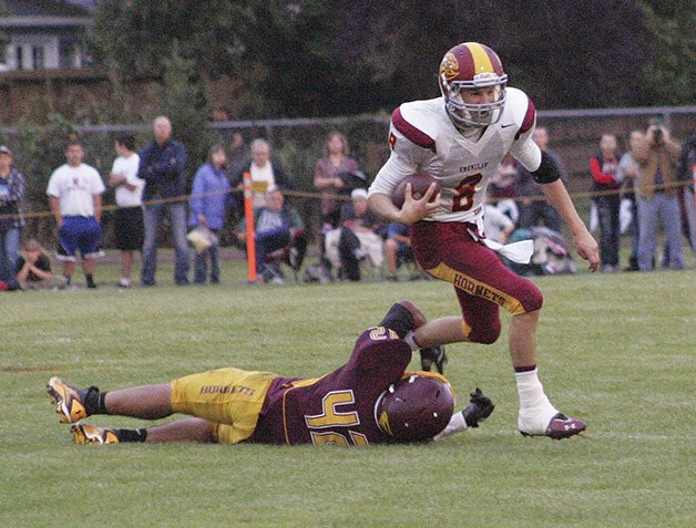 Enumclaw quarterback Peter Nordby breaks a tackle during the game Friday