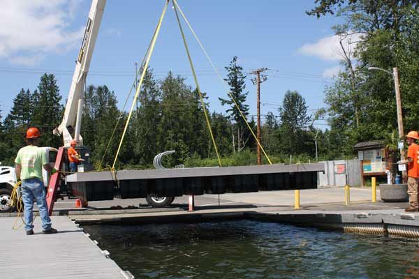 Bonney Lake Public Works employees remove the floating dock at Allan Yorke Park.