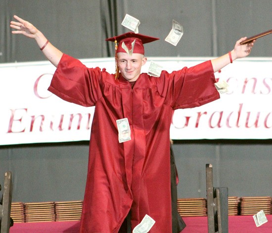 Kyle Couts Russell took the opportunity to celebrate his graduation by throwing money into the air as he descends from the stage.