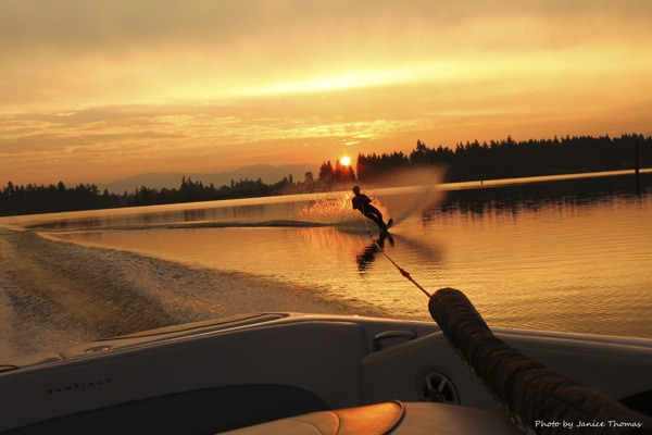 Janice Thomas is one of several area photographers who use Lake Tapps as a backdrop. She is seen here slalom skiing in front of Friday morning's sunrise.