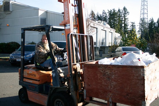 Stew Bowen handles nearly two and a half tons of food donated during last Mayor's Food Drive in Bonney Lake.