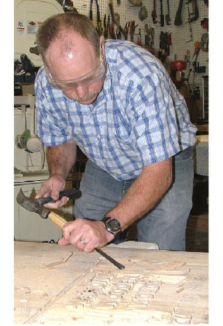 Tom Watson artistically works through several steps before personalized signs are delivered to his customers.