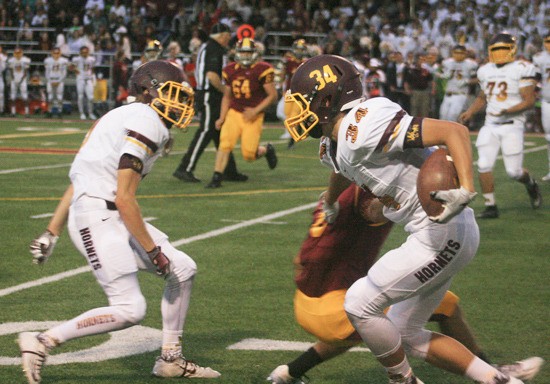 White River running back Luke Northam breaks a tackle at the Expo Center in the Battle of the Bridge last Friday.