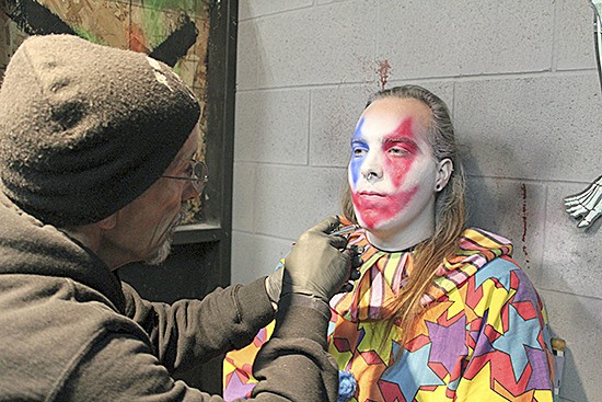 A volunteer gets his face painted for the Fright Factory.