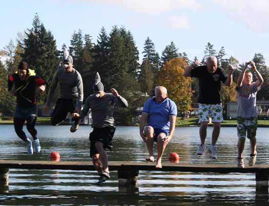 East Pierce Fire and Rescue Chief Jerry Thorsen leads the way into Lake Tapps with a cannonball during the second Plunge Against Domestic Violence Oct. 28.