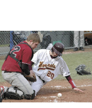 White River’s Dillon Meyers slides safely as the ball gets away from Bethel’s catcher during the Hornets’ eight-run