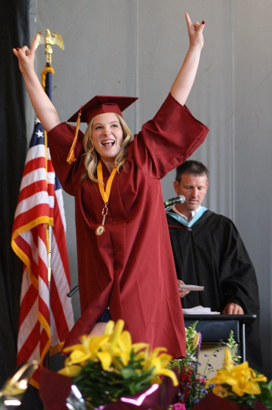 Kenadie Elizabeth Smith celebrates graduation at the White River Amphitheater Friday during the White River High School 2015 commencement ceremony.
